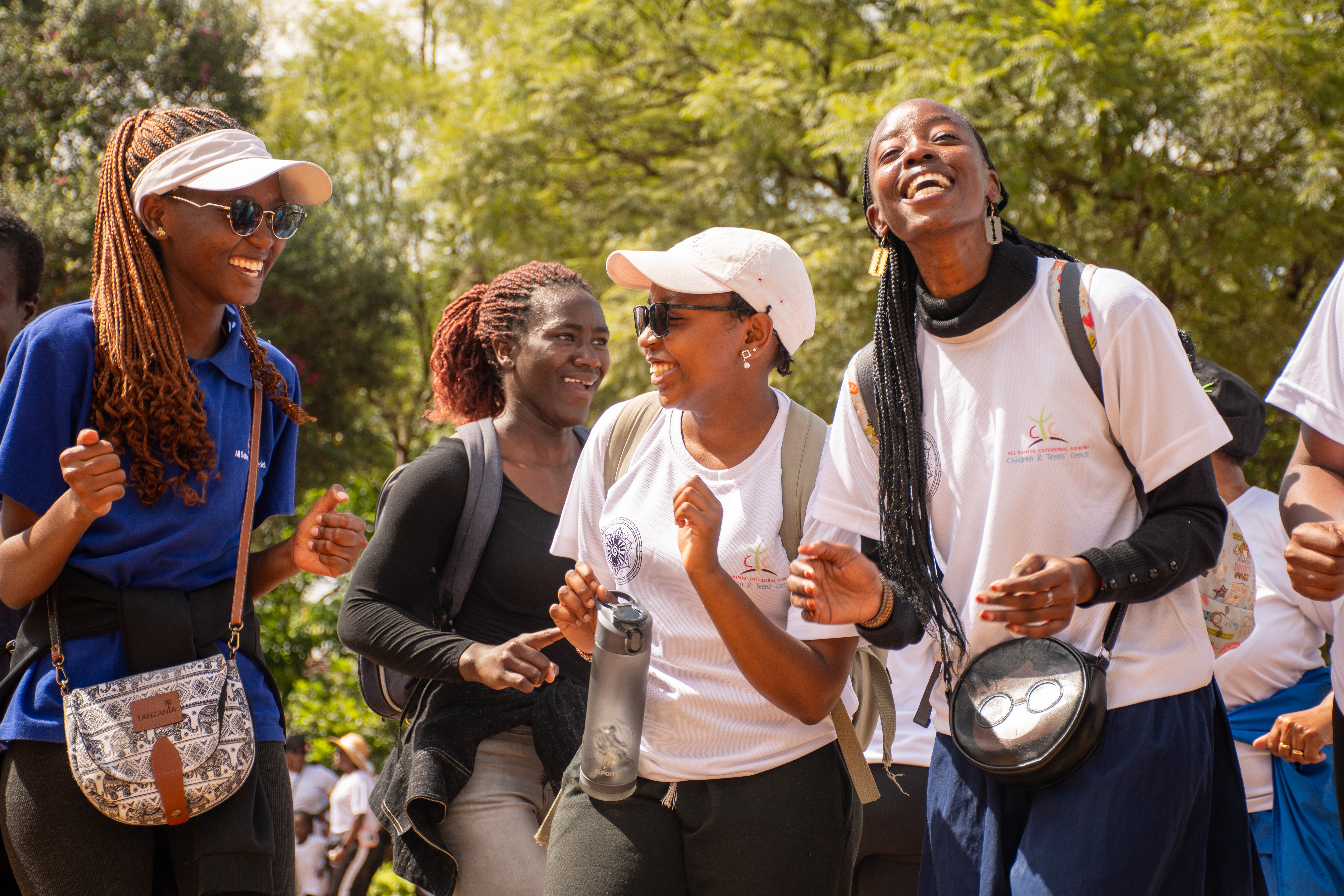 Group of women laughing and dancing at an outdoor festival